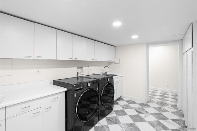 a view of a storage and utility room with washer and dryer
