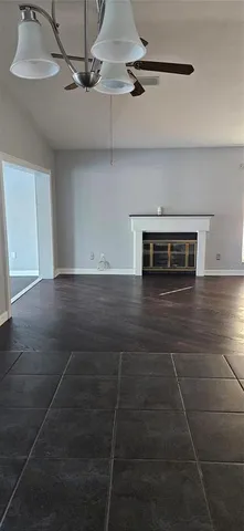 a view of a livingroom with a ceiling fan and window