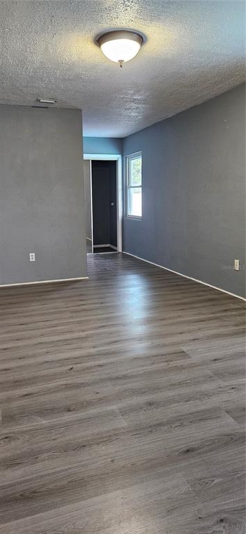 2075 North Keene Road Clearwater, FL 33755 - Photo 21 of 31 an empty room with wooden floor and windows