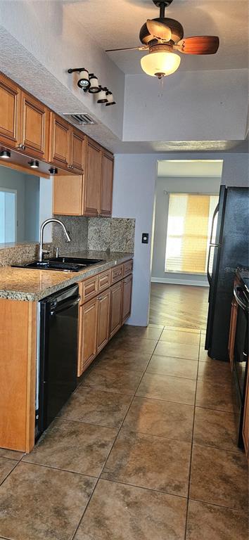 2075 North Keene Road Clearwater, FL 33755 - Photo 28 of 31 a kitchen with stainless steel appliances granite countertop a stove a sink and a microwave