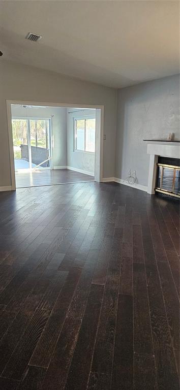2075 North Keene Road Clearwater, FL 33755 - Photo 4 of 31 an empty room with wooden floor and windows
