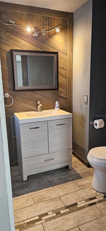 2075 North Keene Road Clearwater, FL 33755 - Photo 8 of 31 a bathroom with a sink a toilet and a mirror