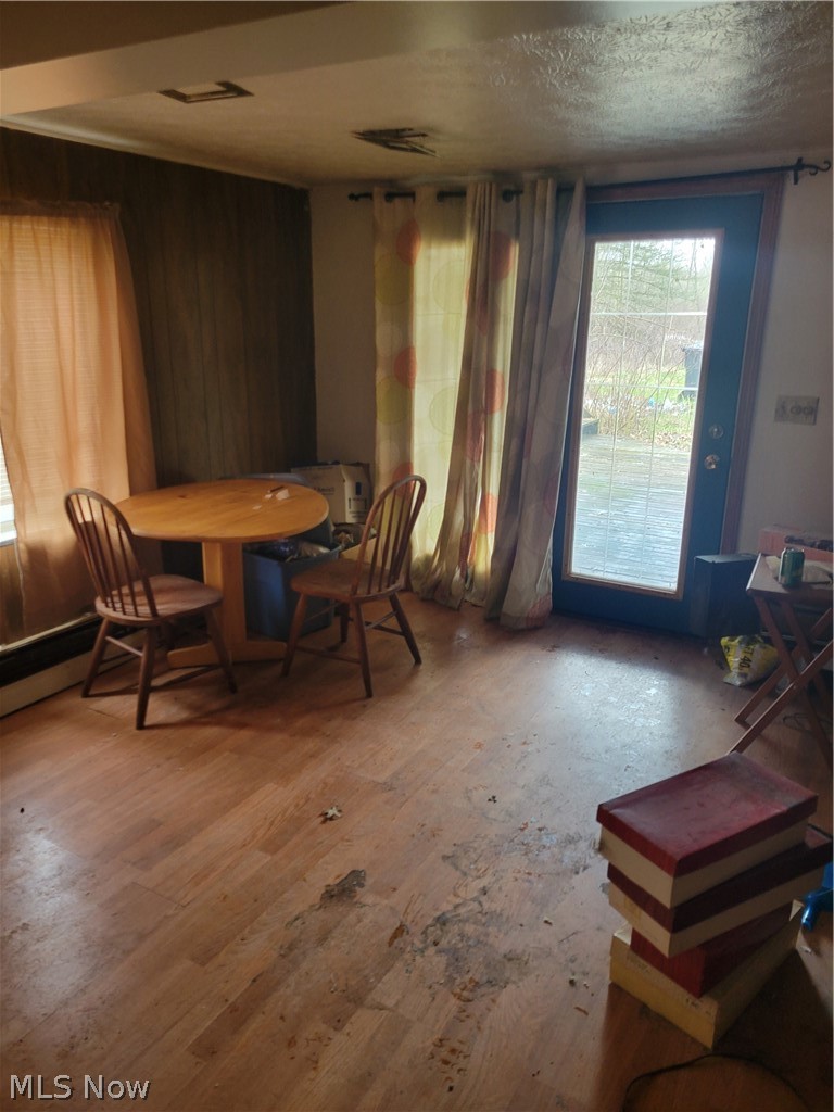 13989 Diagonal Road Salem, OH 44460 - Photo 16 of 18 Dining room featuring a textured ceiling and wood-type flooring