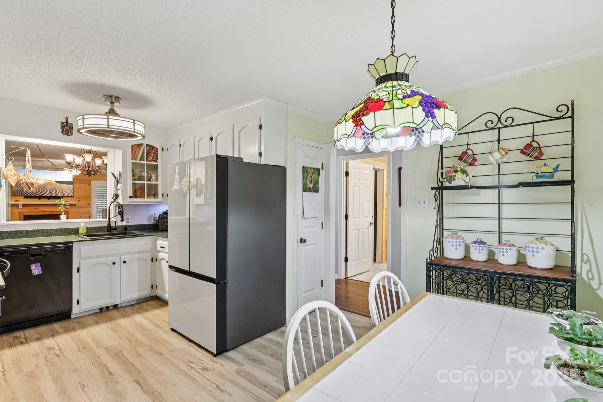 1590 Springpoint Road, Unit E Rock Hill, SC 29732 - Photo 13 of 38 a kitchen with stainless steel appliances kitchen island granite countertop a refrigerator and a stove top oven