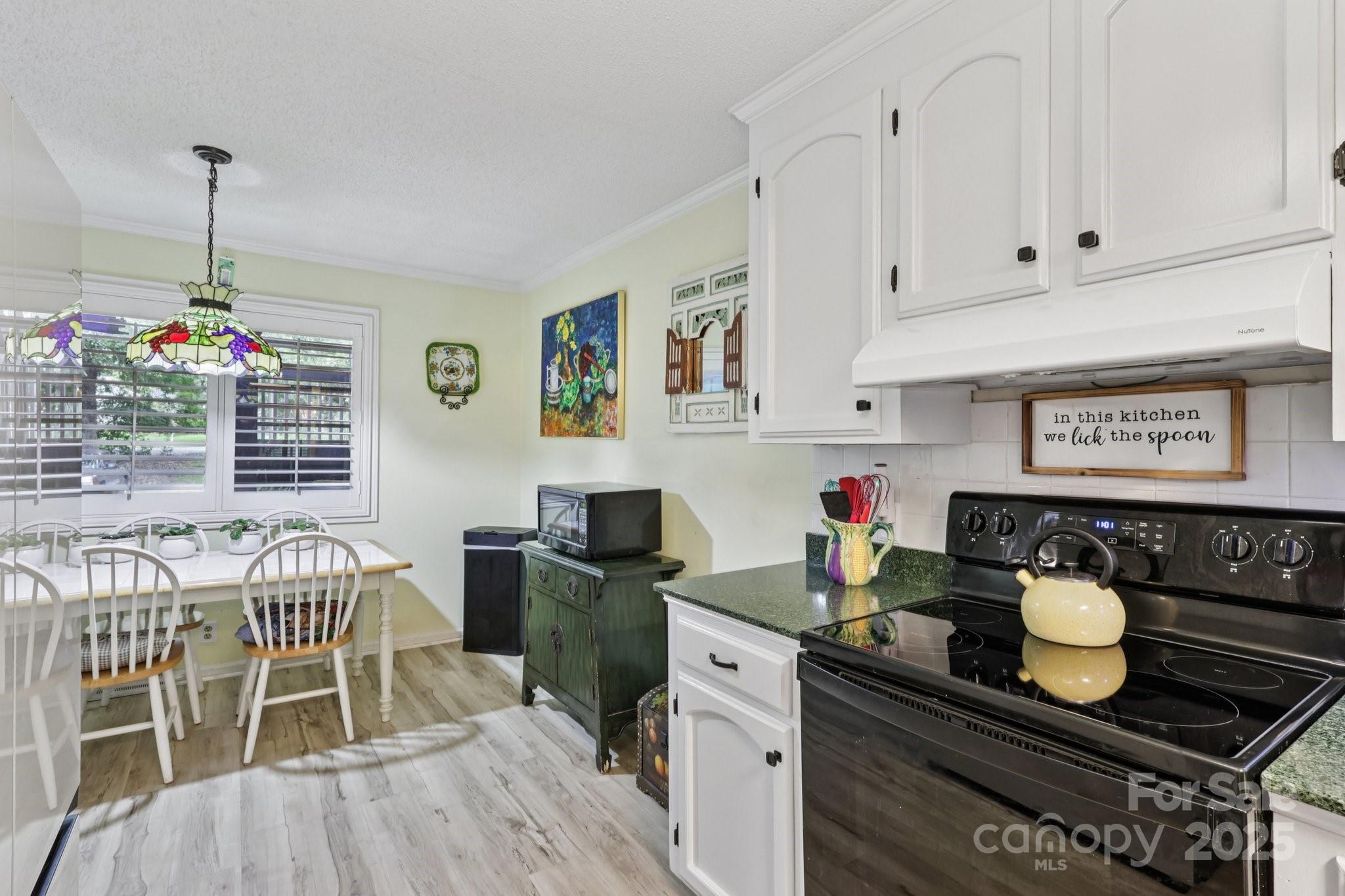 1590 Springpoint Road, Unit E Rock Hill, SC 29732 - Photo 18 of 38 a view of kitchen island sink dining table and chairs