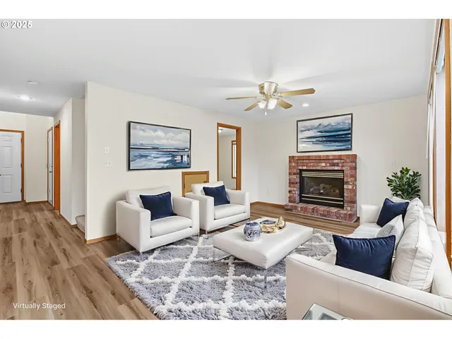 a living room with furniture a fireplace and a chandelier