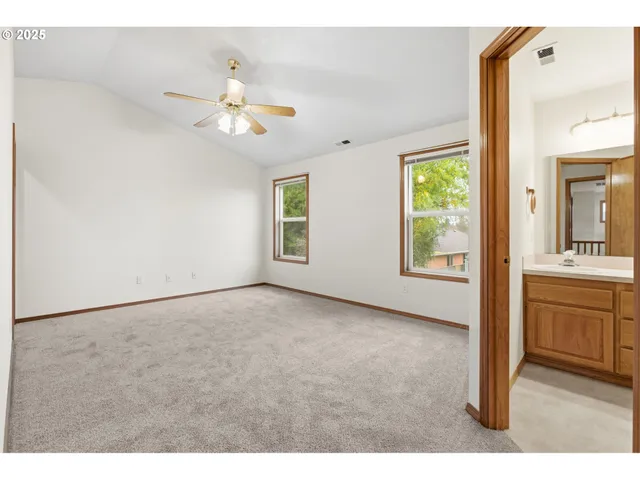a bedroom with a large bed and flat tv screen