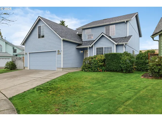 a front view of a house with a yard and garage