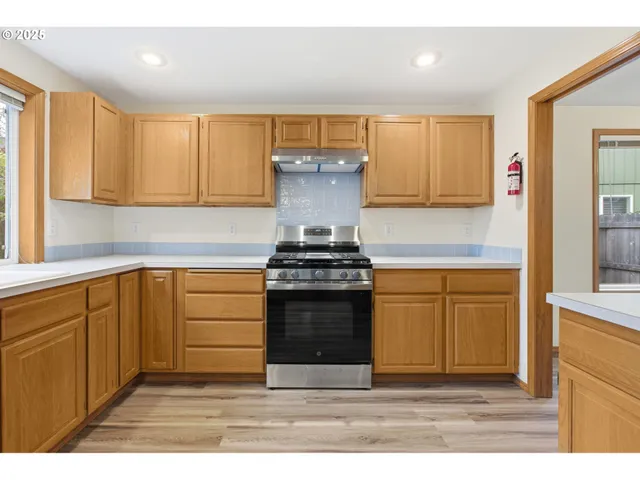 a kitchen with stainless steel appliances granite countertop a stove and a sink