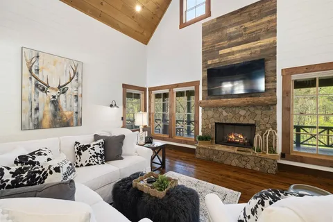 a living room with lots of furniture and a wooden floor