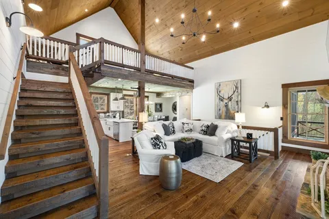 a dining room with furniture and wooden floor