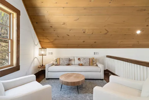 a dining room with wooden floor table and chairs