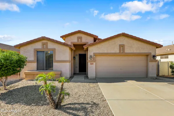 a front view of a house with a garden