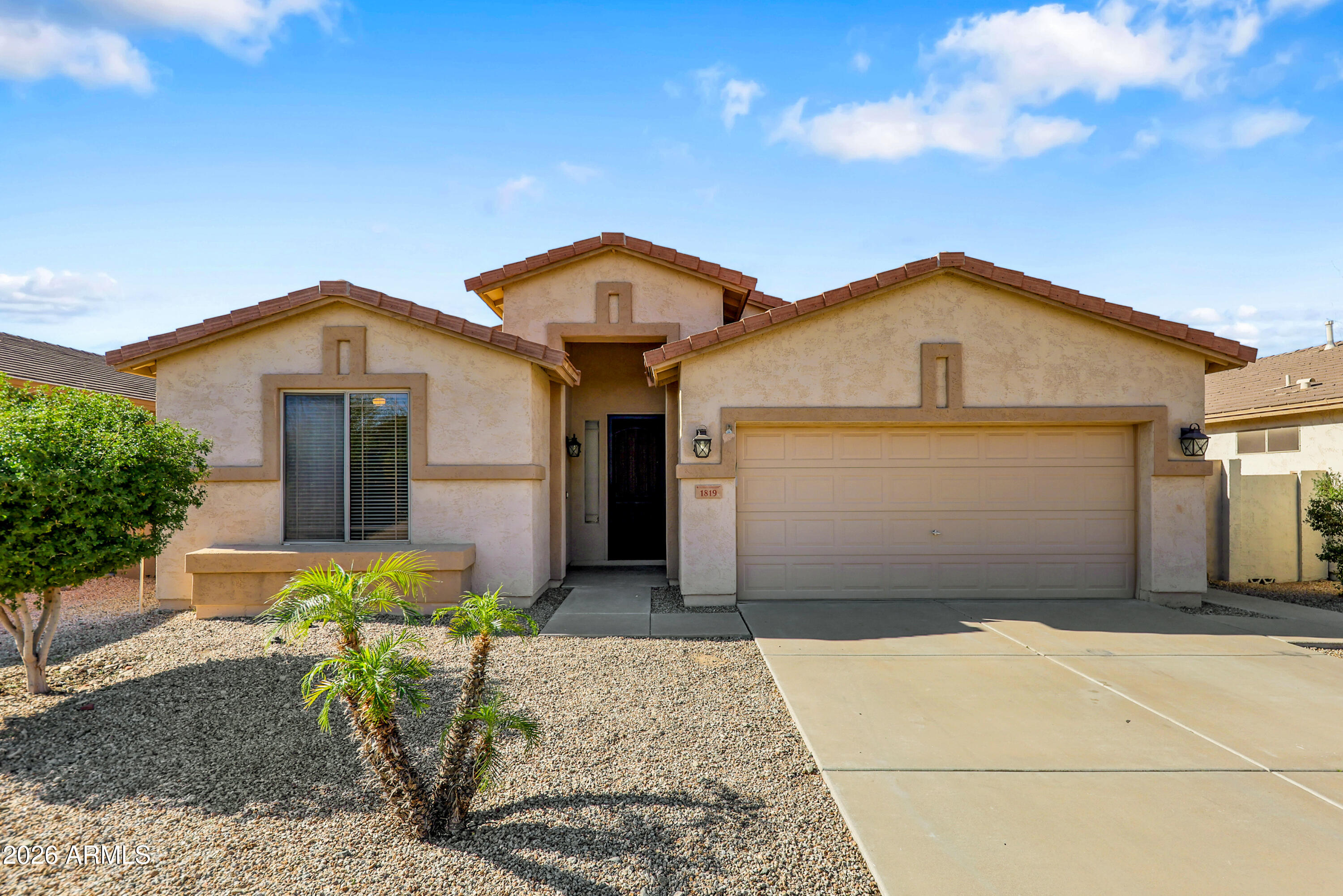 a front view of a house with a garden