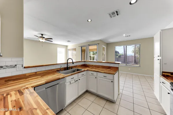 a large kitchen with a sink and cabinets