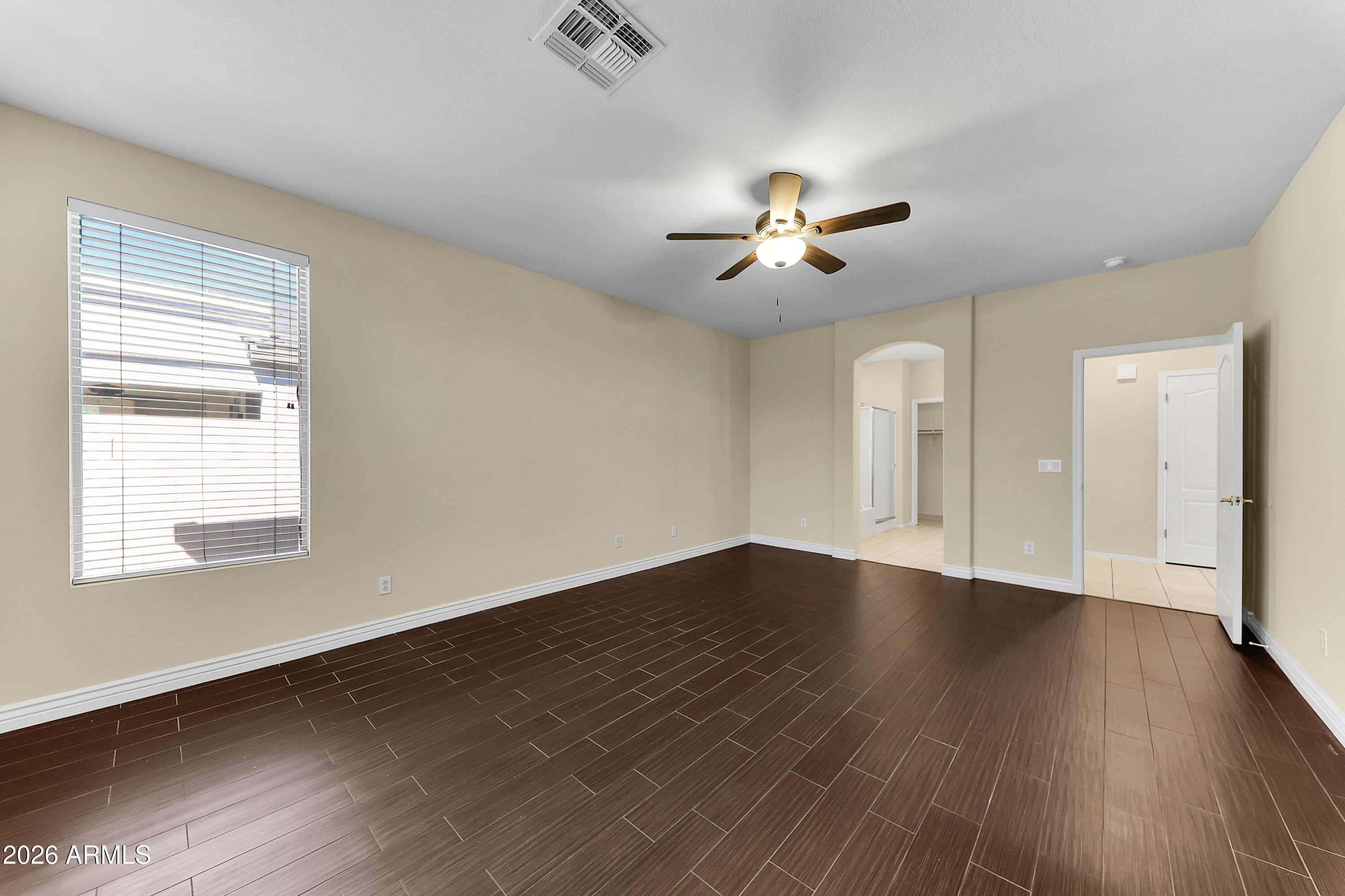 1819 West Nighthawk Way Phoenix, AZ 85045 - Photo 17 of 25 a view of an empty room with a window and wooden floor