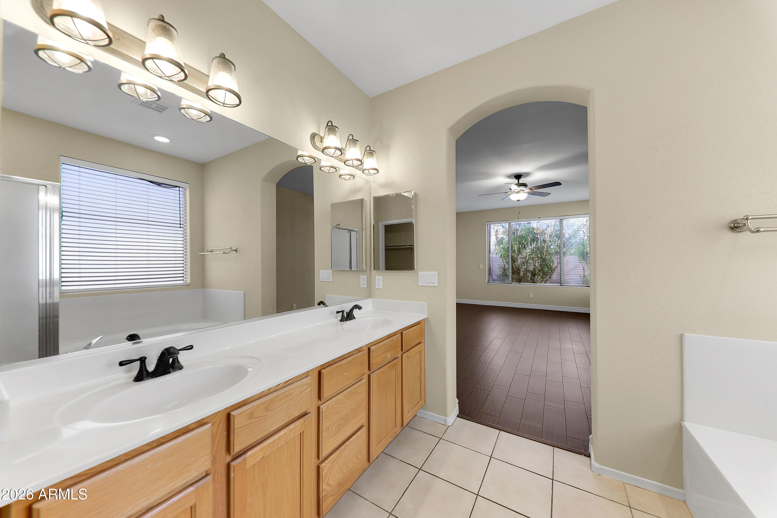 1819 West Nighthawk Way Phoenix, AZ 85045 - Photo 19 of 25 a spacious bathroom with a double vanity sink a mirror and a bathtub