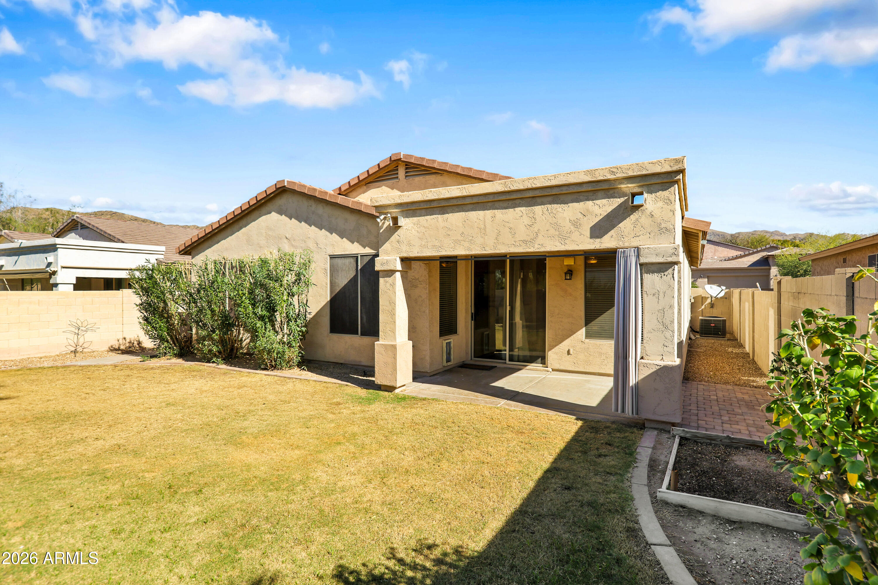 1819 West Nighthawk Way Phoenix, AZ 85045 - Photo 23 of 25 a front view of a house with a yard and potted plants