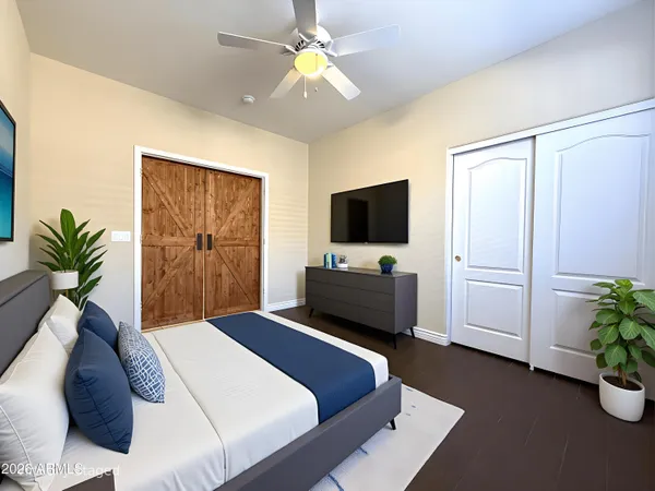 a bedroom with a bed potted plant on the dresser and a chandelier