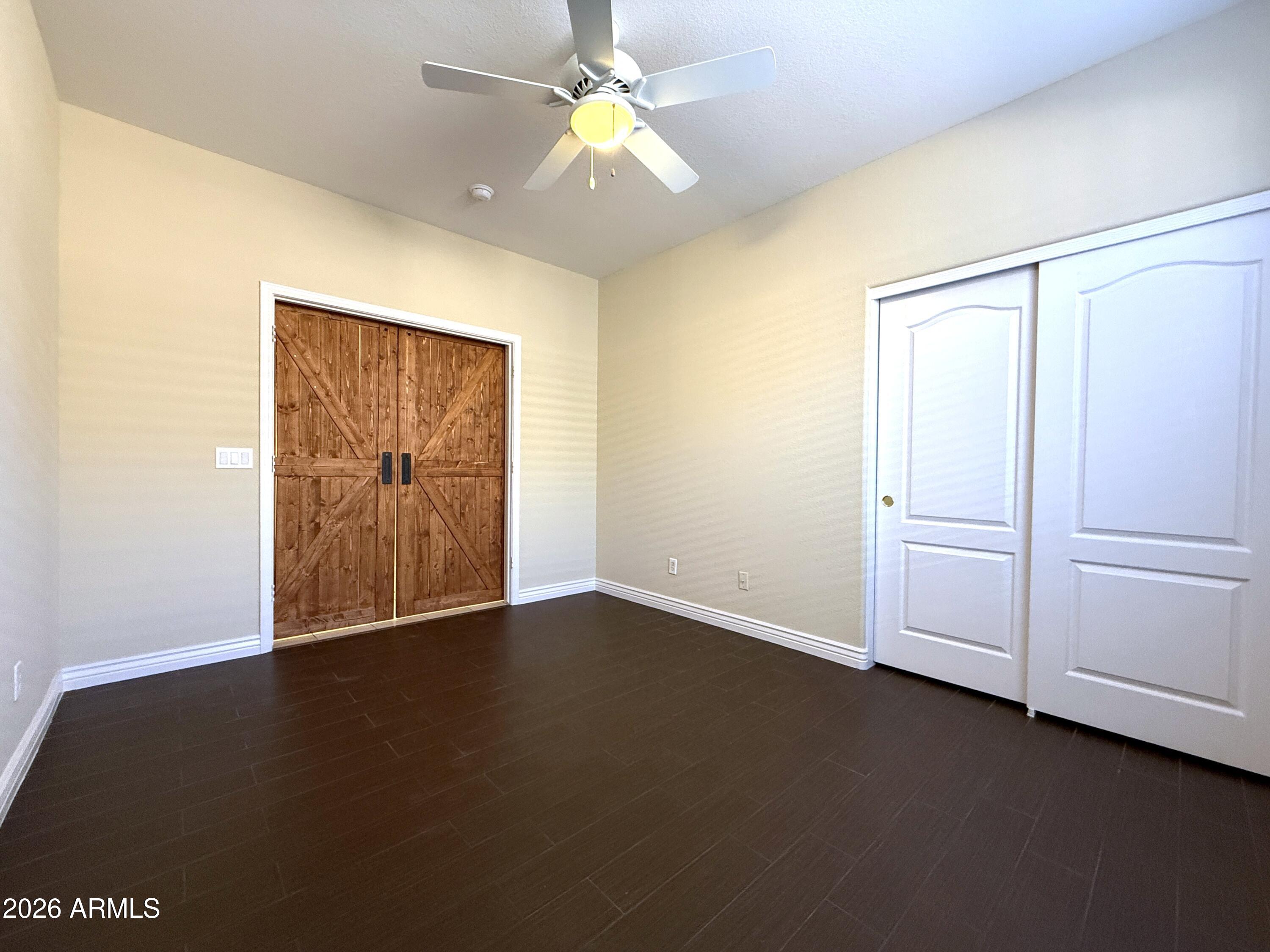 1819 West Nighthawk Way Phoenix, AZ 85045 - Photo 4 of 25 a view of an empty room with closet and a chandelier fan