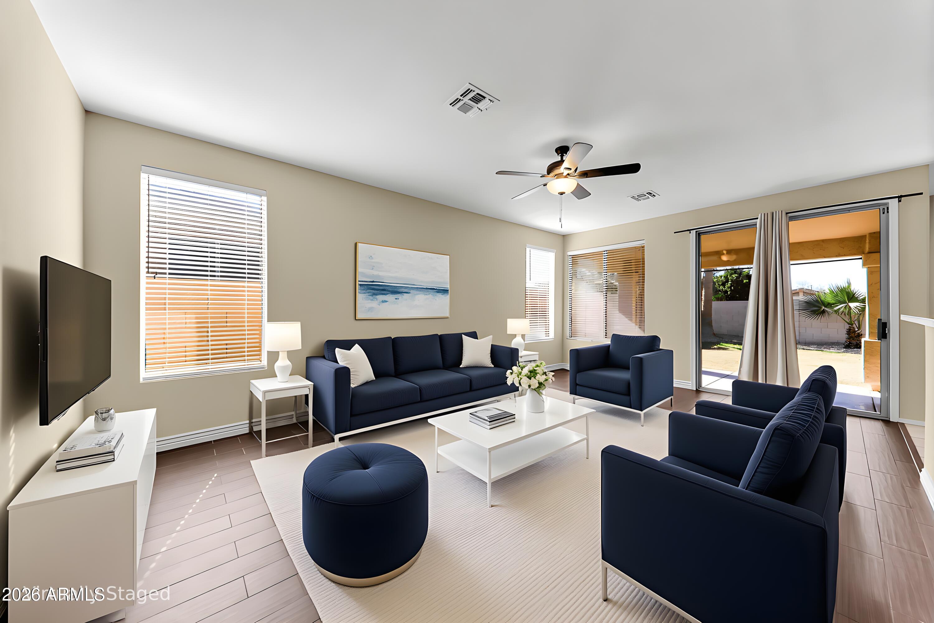 1819 West Nighthawk Way Phoenix, AZ 85045 - Photo 5 of 25 a living room with furniture a ceiling fan and a flat screen tv