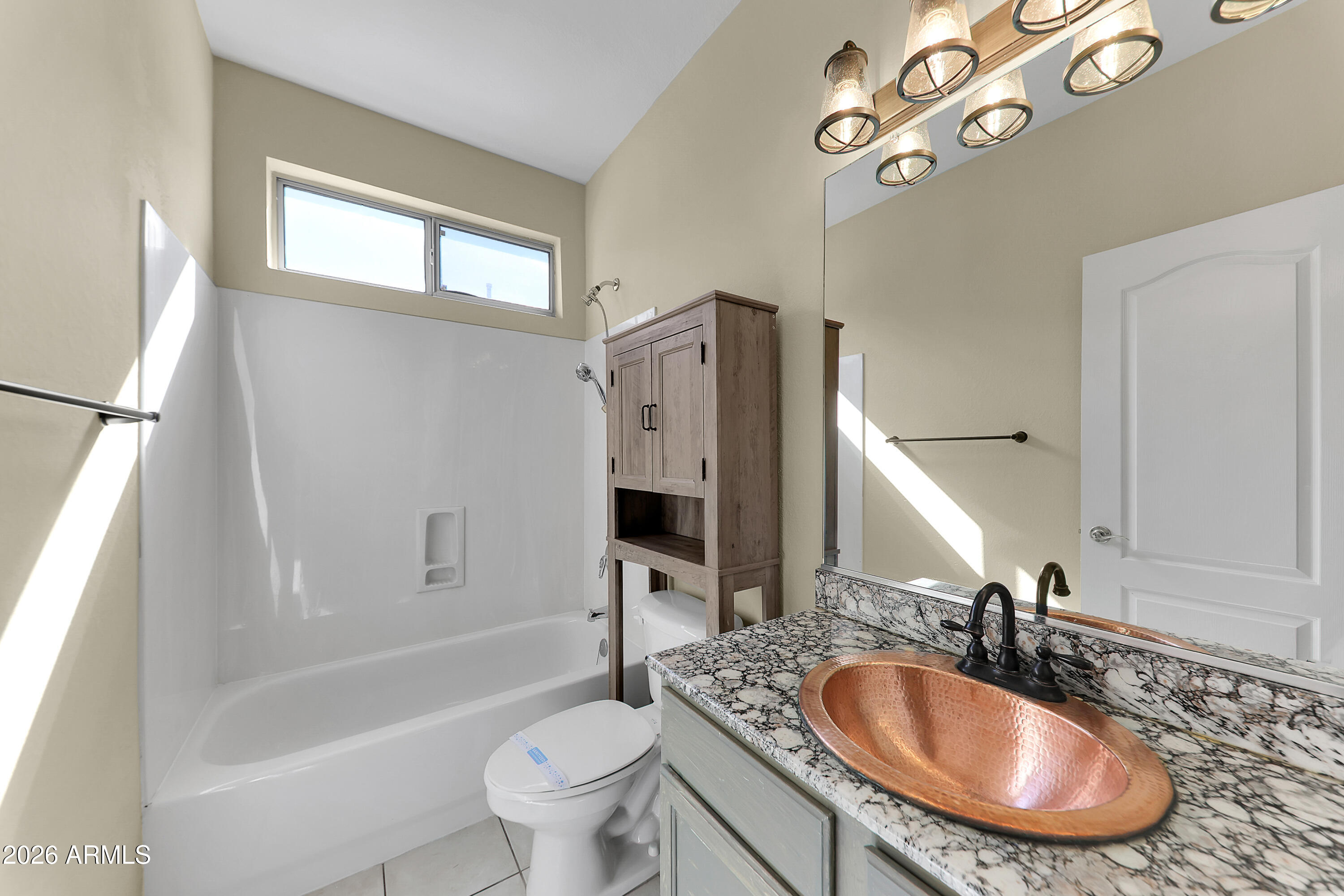 1819 West Nighthawk Way Phoenix, AZ 85045 - Photo 7 of 25 a bathroom with a granite countertop sink a toilet a mirror a bathtub and shower