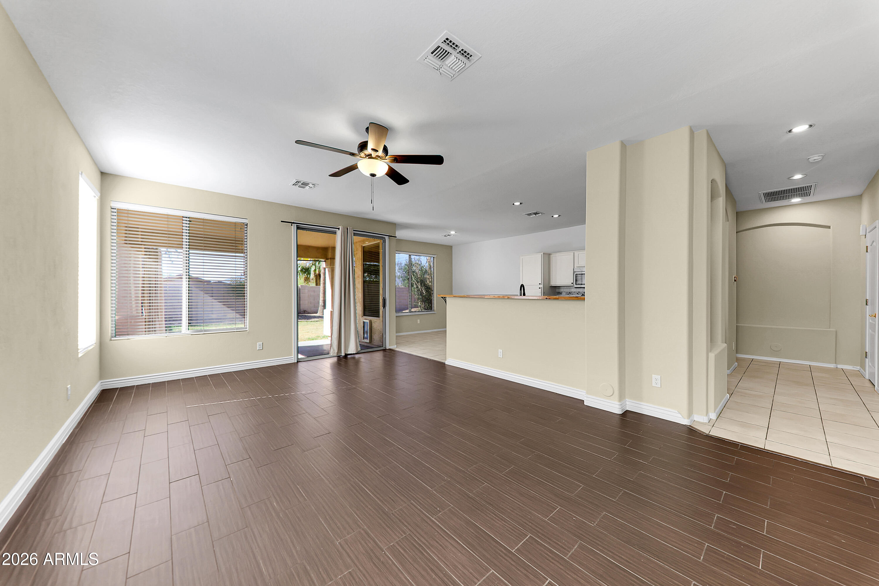 1819 West Nighthawk Way Phoenix, AZ 85045 - Photo 10 of 25 a view of an empty room with window and wooden floor