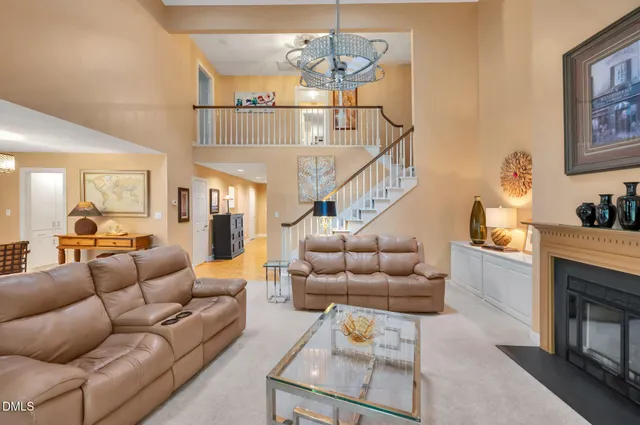 a living room with furniture a flat screen tv and a large window