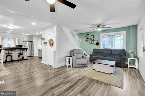a living room with fireplace furniture and a window