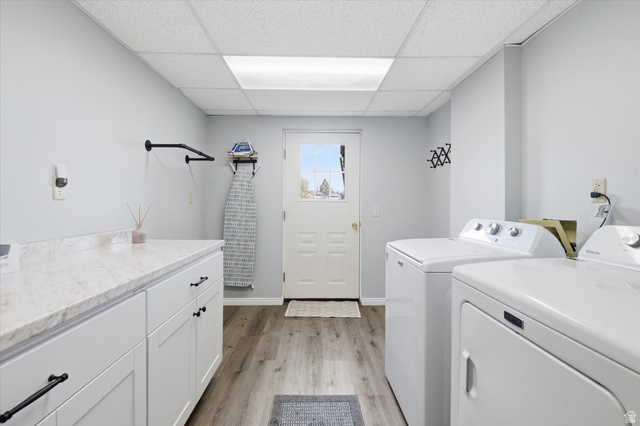 45 West 100 South Mendon, UT 84325 - Photo 32 of 64 Laundry area with light wood-style flooring, a drop ceiling, separate washer and dryer, and cabinet space