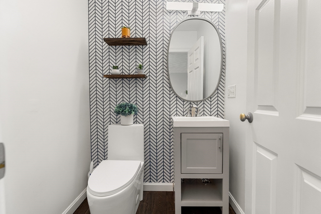 2 Ricciuti Drive, Unit 9 Quincy, MA 02169 - Photo 12 of 40 a bathroom with a toilet a sink and a mirror