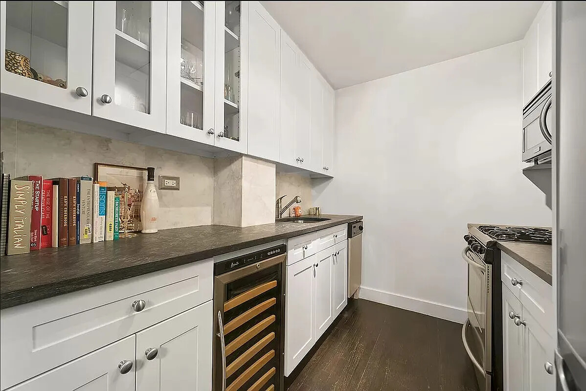 250 Mercer Street, Unit C318 Manhattan, NY 10012 - Photo 4 of 14 a kitchen with stainless steel appliances granite countertop a sink and a stove