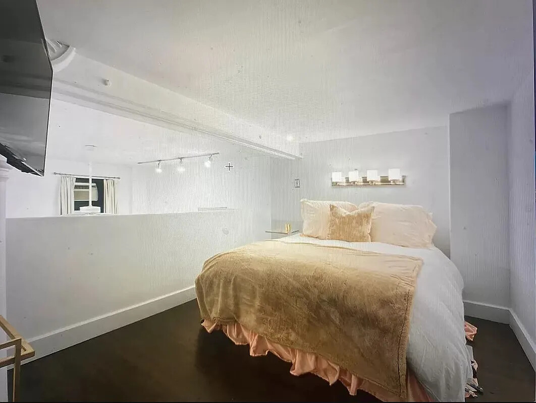 250 Mercer Street, Unit C318 Manhattan, NY 10012 - Photo 5 of 14 a bedroom with a bed and a window