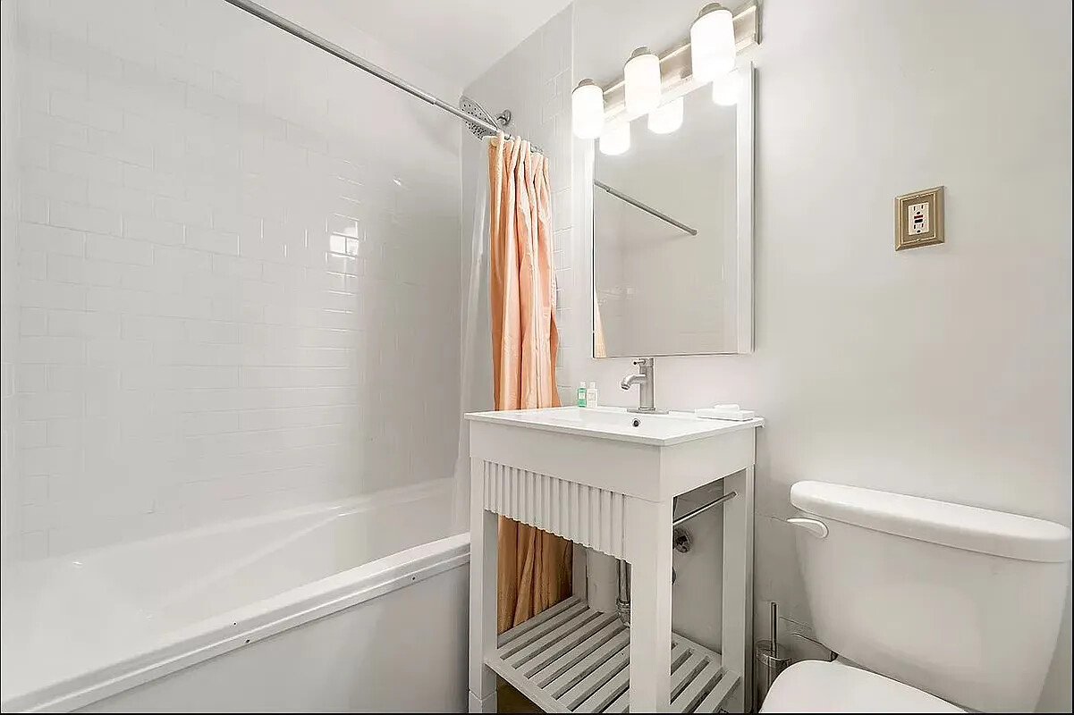 250 Mercer Street, Unit C318 Manhattan, NY 10012 - Photo 6 of 14 a bathroom with a sink a toilet and shower