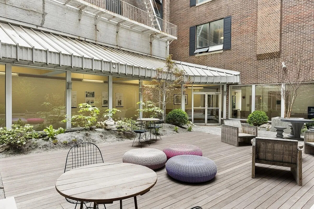 250 Mercer Street, Unit C318 Manhattan, NY 10012 - Photo 8 of 14 a view of a patio with couches table and chairs with wooden floor and plants