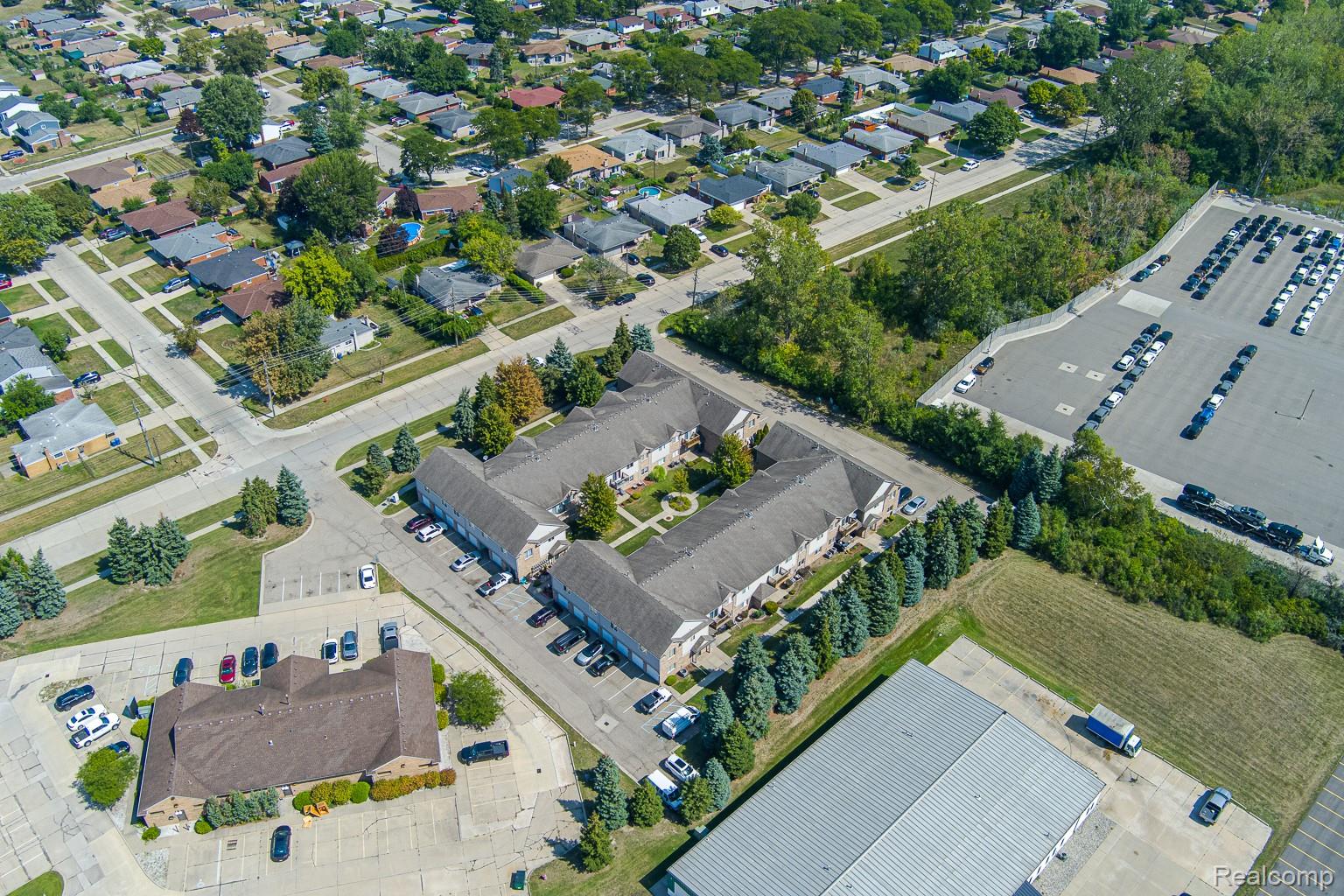 2154 Frazho Road Warren, MI 48091 - Photo 31 of 36 U-shaped multi-unit property with a central courtyard, surrounding residential neighborhood, and a large adjacent parking facility