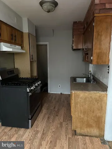 a kitchen with granite countertop a stove and a refrigerator