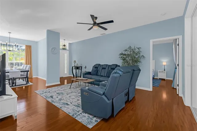 a living room with furniture and a wooden floor