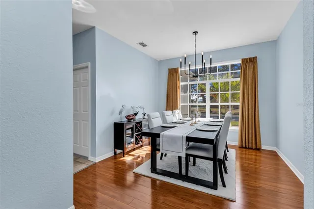 a view of a dining room with furniture window and wooden floor
