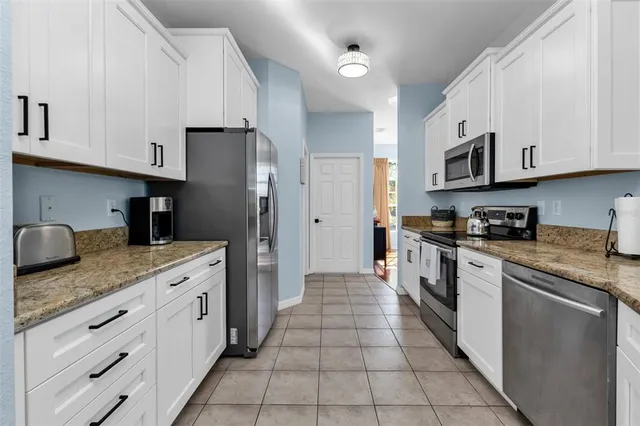a dining room with furniture a chandelier and window