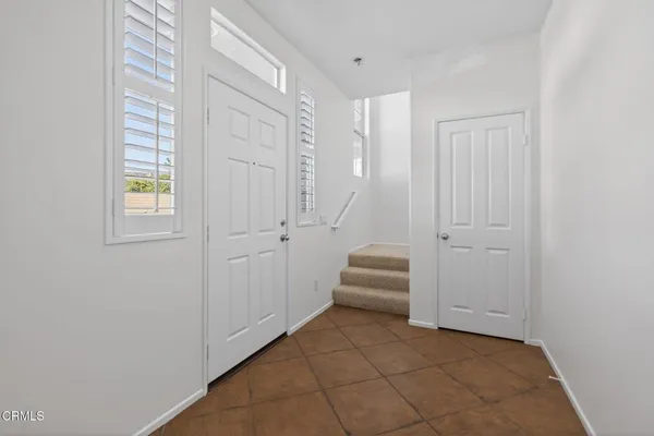 a view of a room with white walls and sliding door