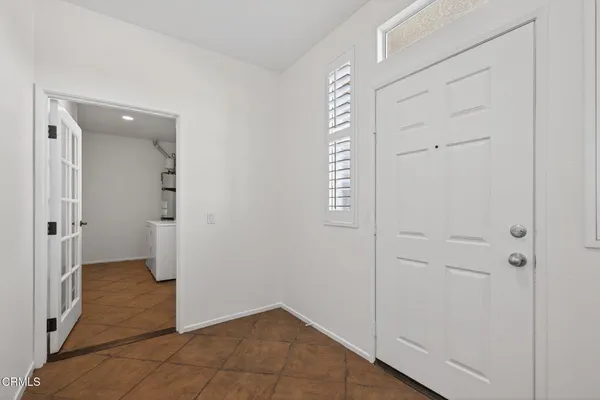 a view of empty room with wooden floor and fireplace