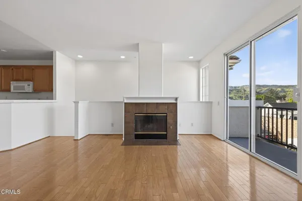 a view of a livingroom with an empty space and a fireplace