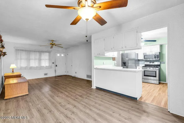 a view of a kitchen with wooden floor