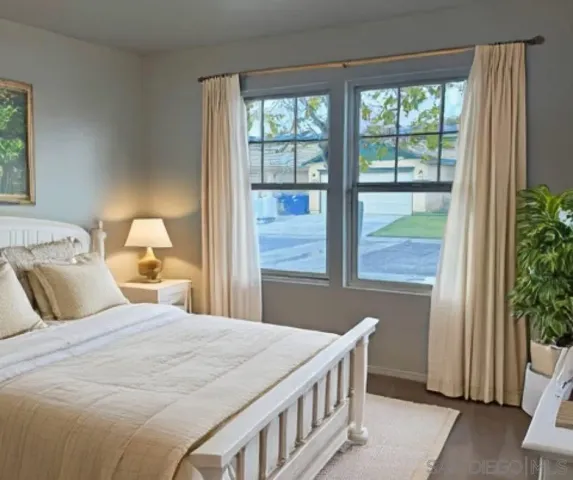 a bedroom with a bed and a window