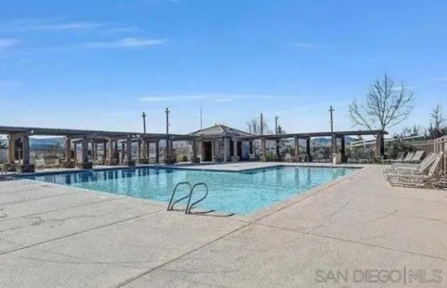 a view of a swimming pool with a patio