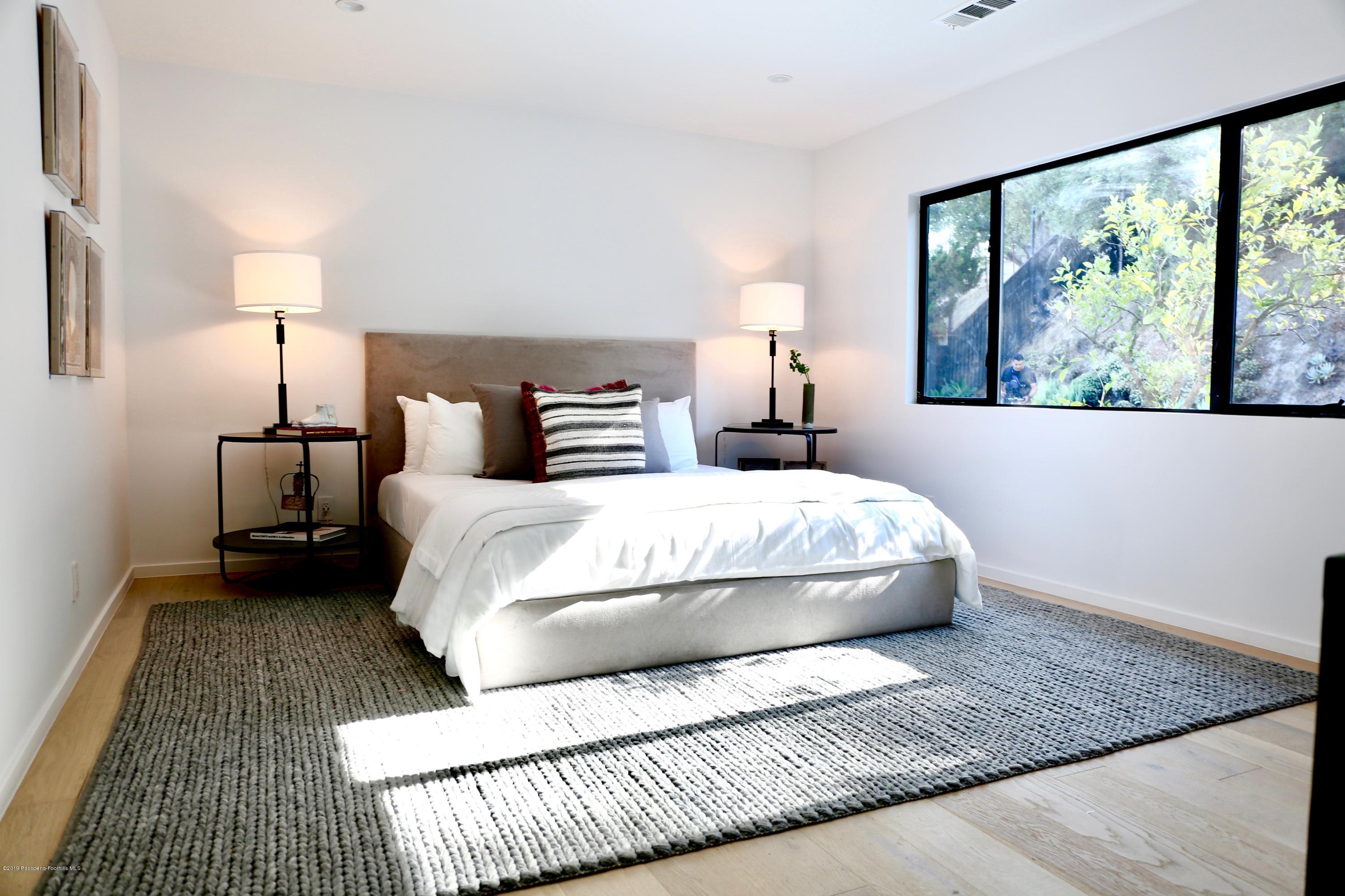 250 La Mirada Road Pasadena, CA 91105 - Photo 34 of 42 a bedroom with a bed wooden floor and window