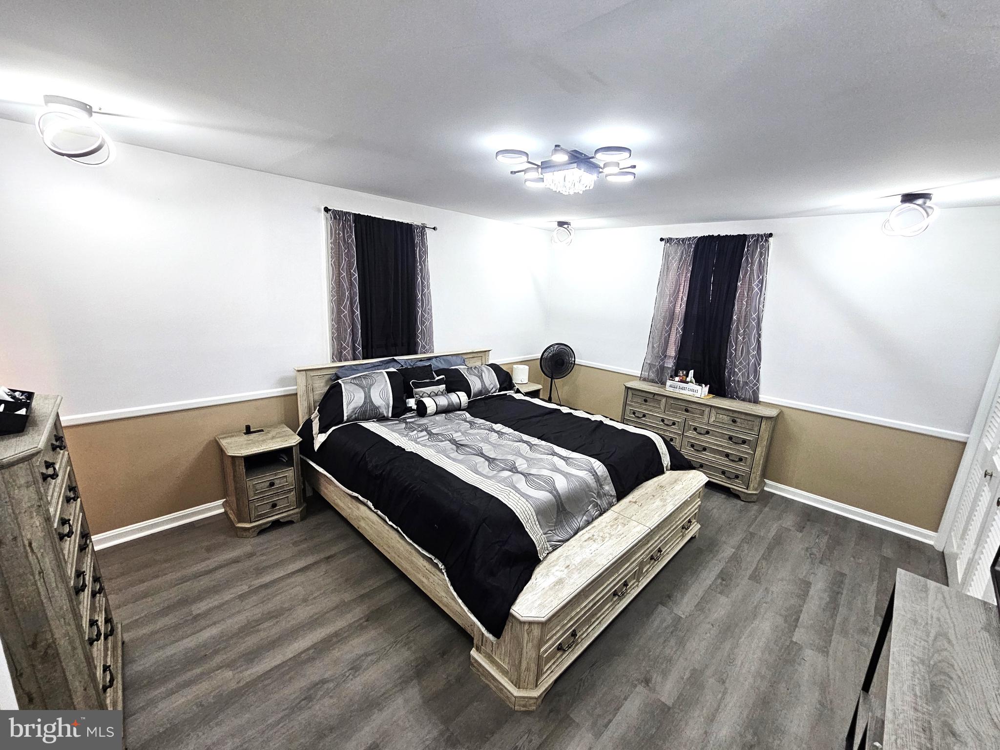 757 Auburn Mill Road Hockessin, DE 19707 - Photo 8 of 10 a bedroom with a bed and a chandelier