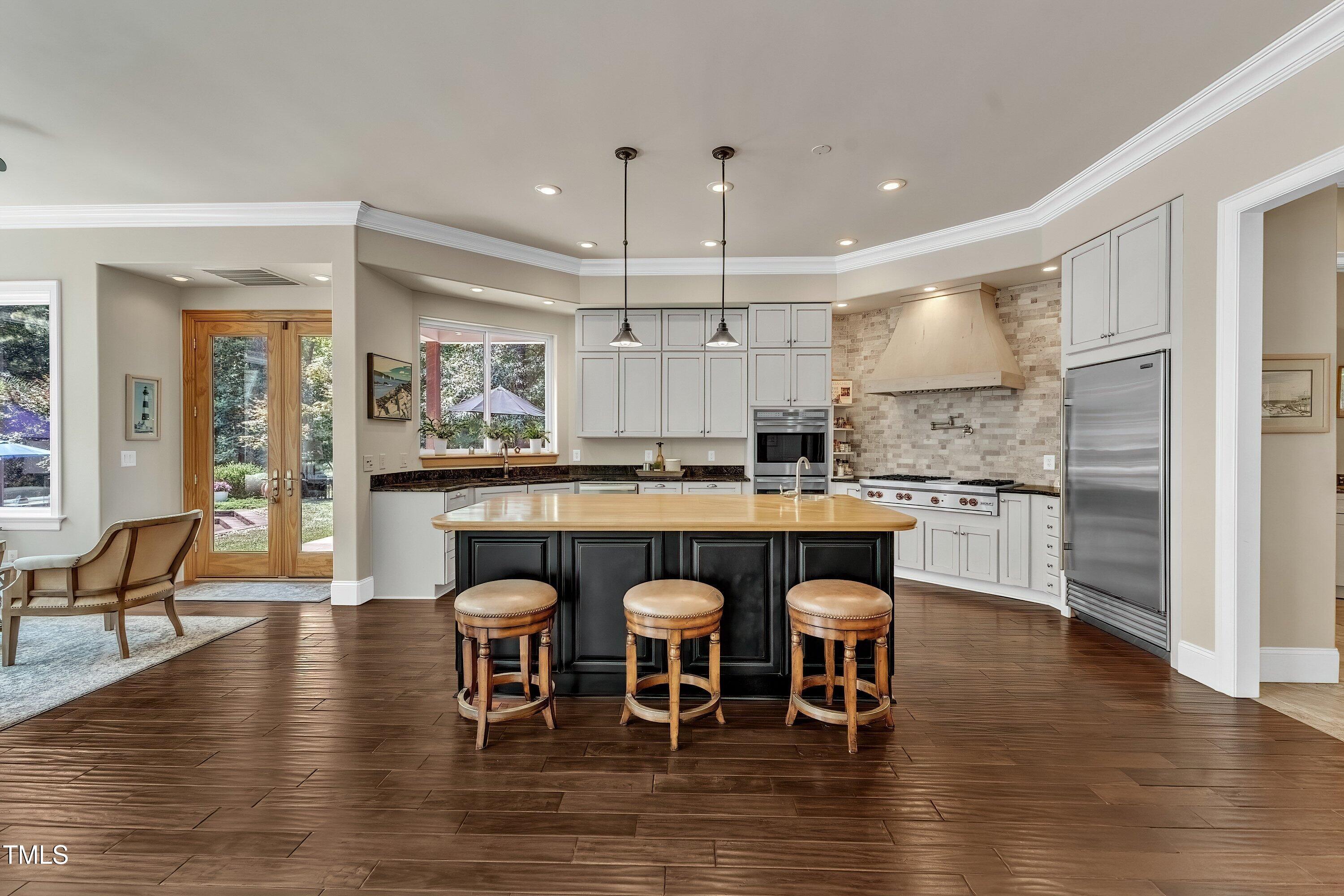 1004 Tobiano Lane Raleigh, NC 27614 - Photo 14 of 48 a kitchen with granite countertop a table chairs stove a sink and dishwasher