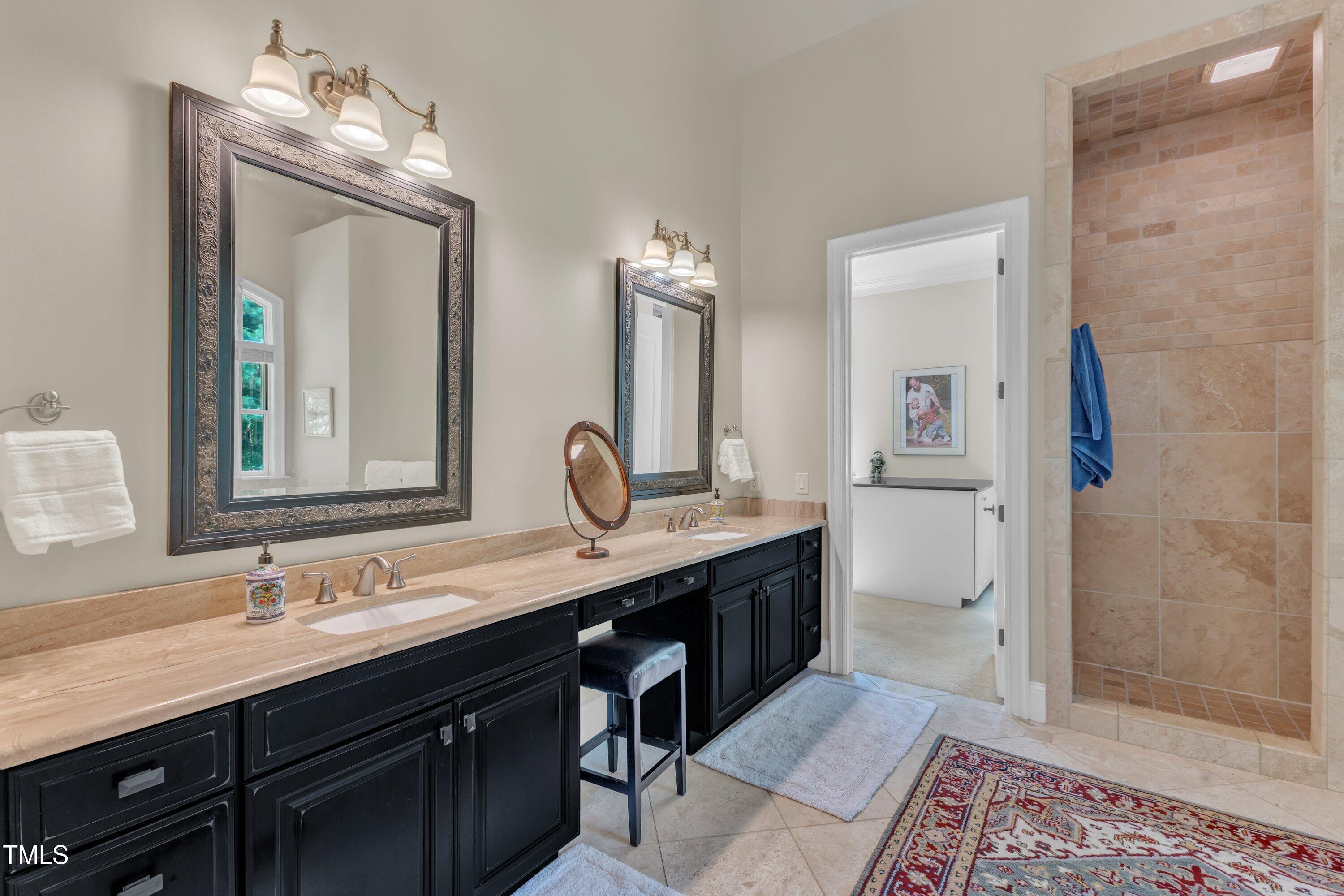 1004 Tobiano Lane Raleigh, NC 27614 - Photo 20 of 48 a bathroom with double vanity sinks and a mirror